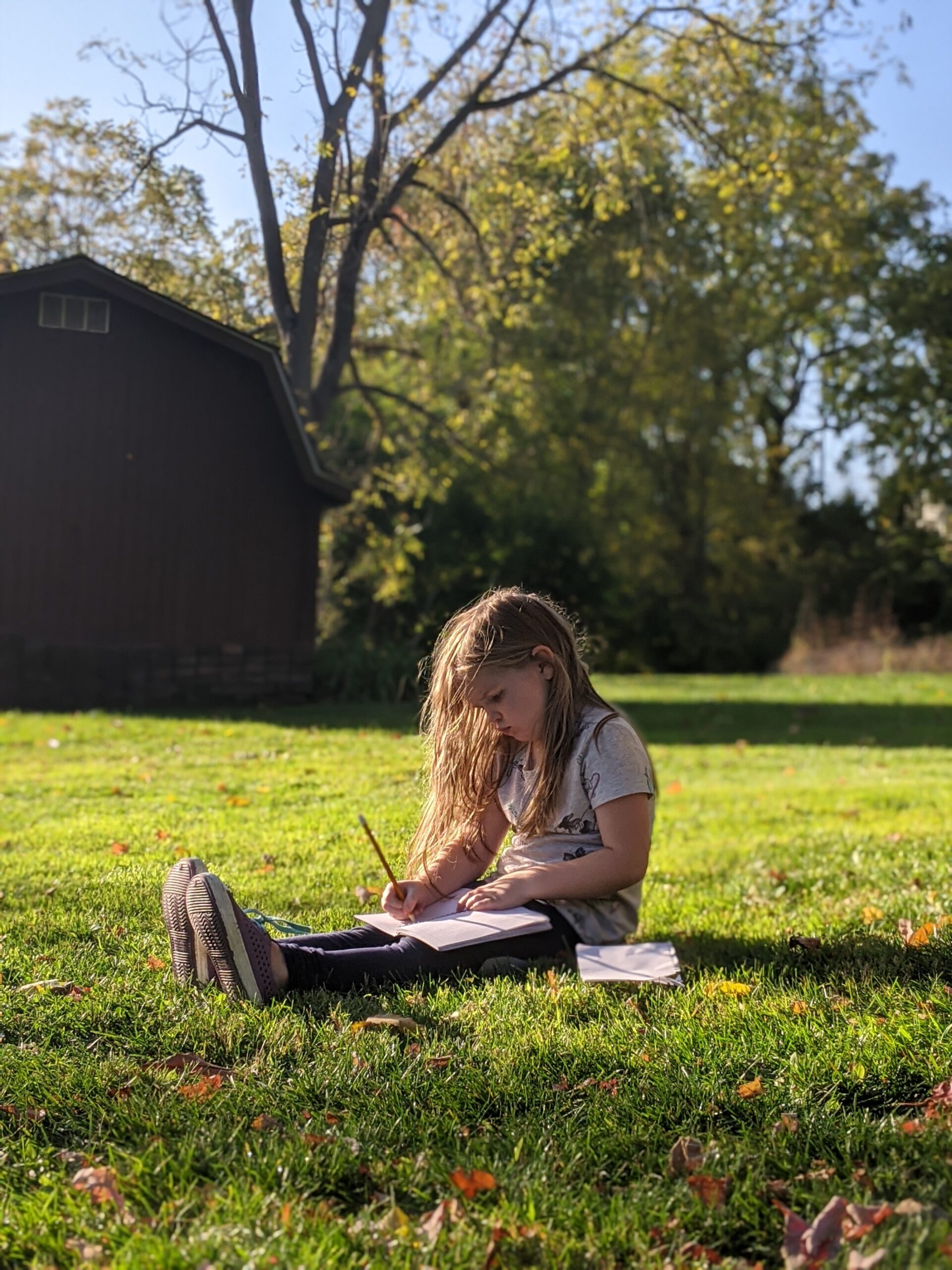 Picture of girl writing outside